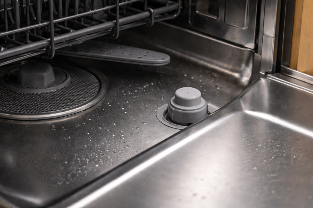 Close-up of the dishwasher float inside the tub that activates the float switch when the water level rises.